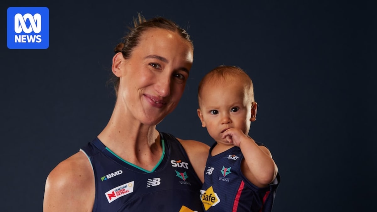 Emily Mannix holding daughter Mabel, both wearing Melbourne Vixens netball jerseys