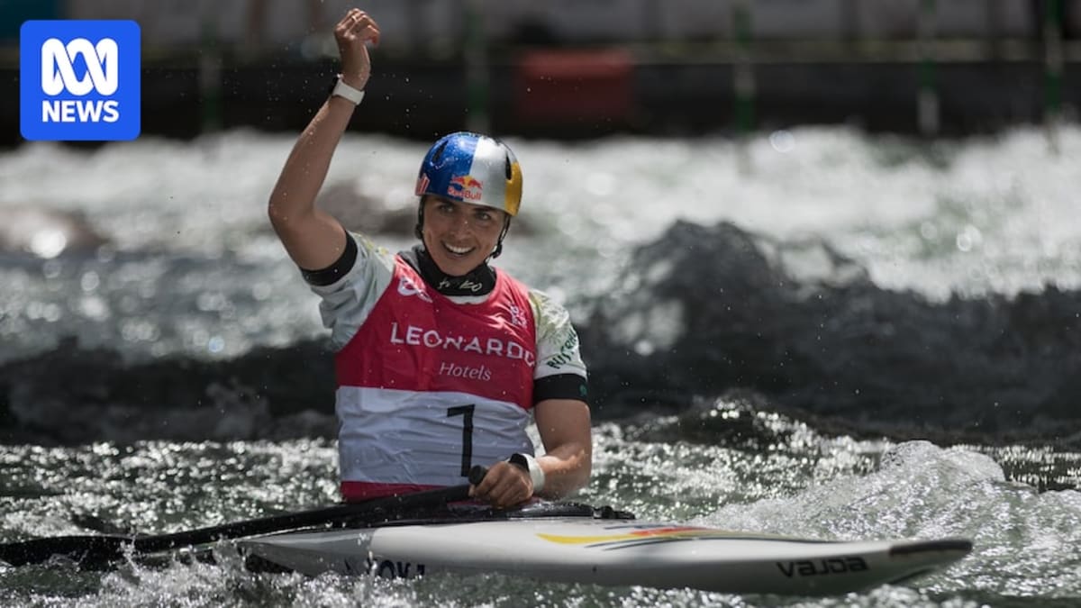 Jessica Fox celebrates on podium holding gold medal after winning C1 canoe slalom event