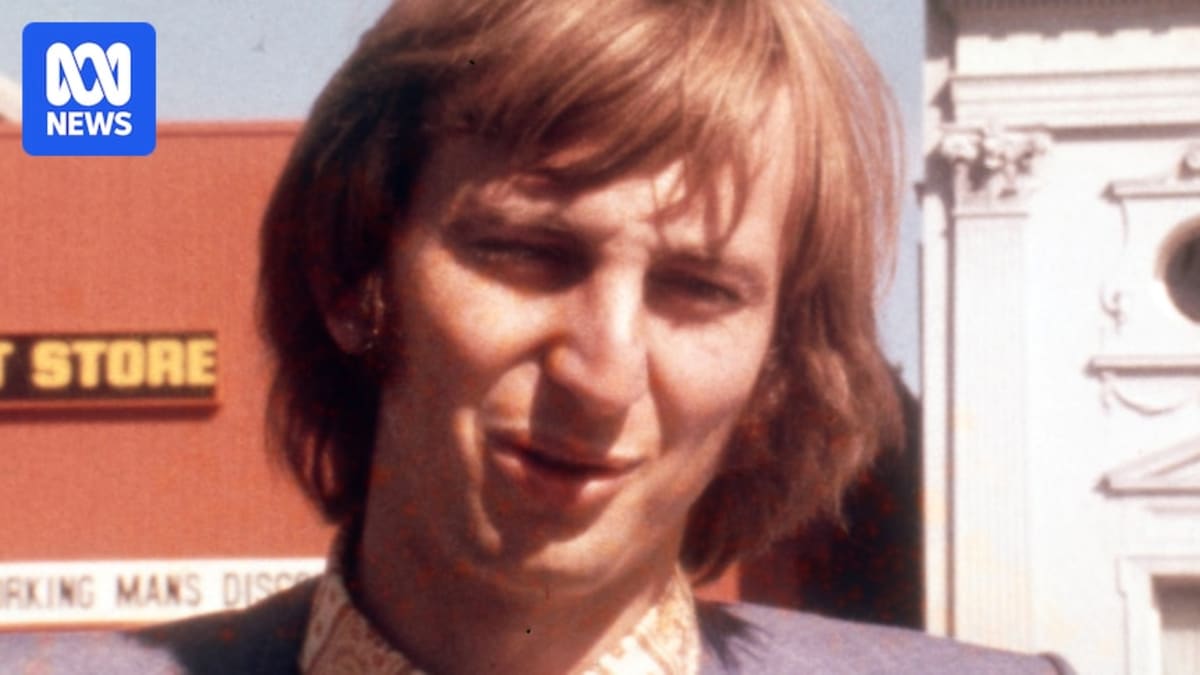 Dennis Cometti speaking into microphone during AFL broadcast, smiling warmly at camera