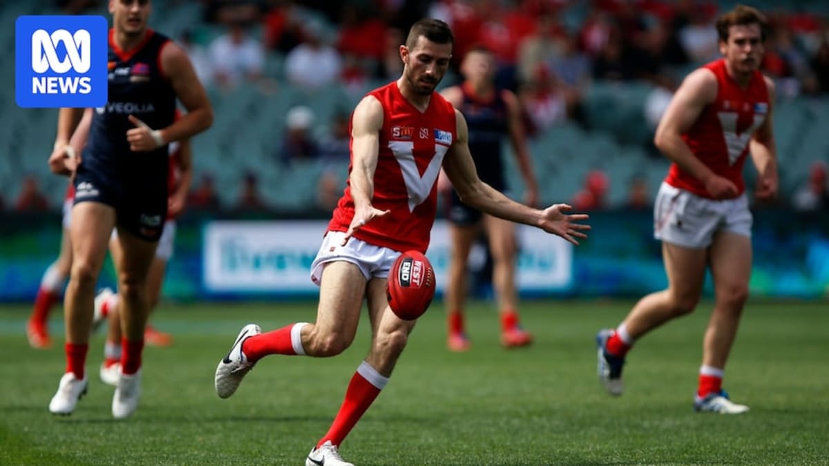 Leigh Ryswyk in North Adelaide football uniform smiling on field after match
