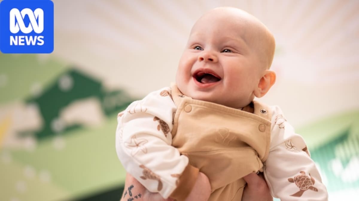 Eight-month-old baby Bohdi Higginson smiling with his mother Stephanie after receiving world-first epilepsy treatment
