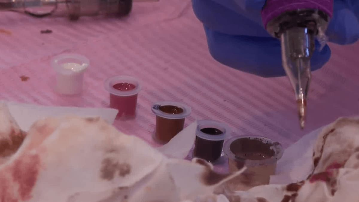 Breast cancer survivor Krista Powers smiling after completing restorative three-dimensional tattooing procedure in Cincinnati