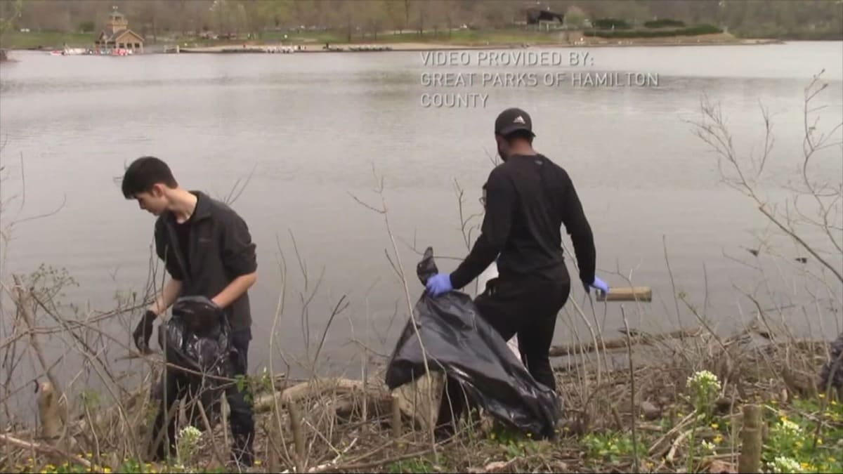 Volunteers cleaning up trash and debris along the banks of Winton Lake at Winton Woods