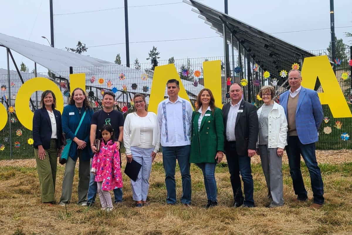 Community members at ribbon cutting ceremony for decorated solar panel installation in South Everett park