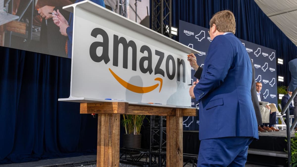 Governor Tate Reeves speaking at podium during Amazon investment announcement in Mississippi