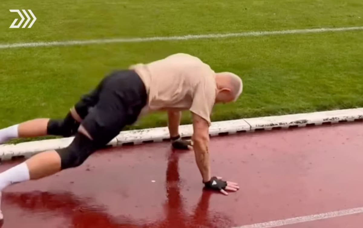 Athlete Kevin Ociepka performing burpee broad jump on outdoor track in Germany