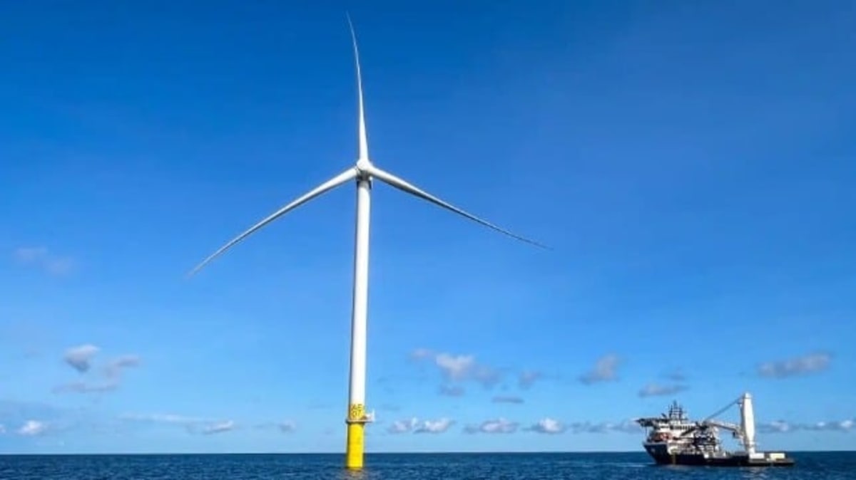 Offshore wind turbines standing in ocean waters off Rhode Island coast generating renewable energy