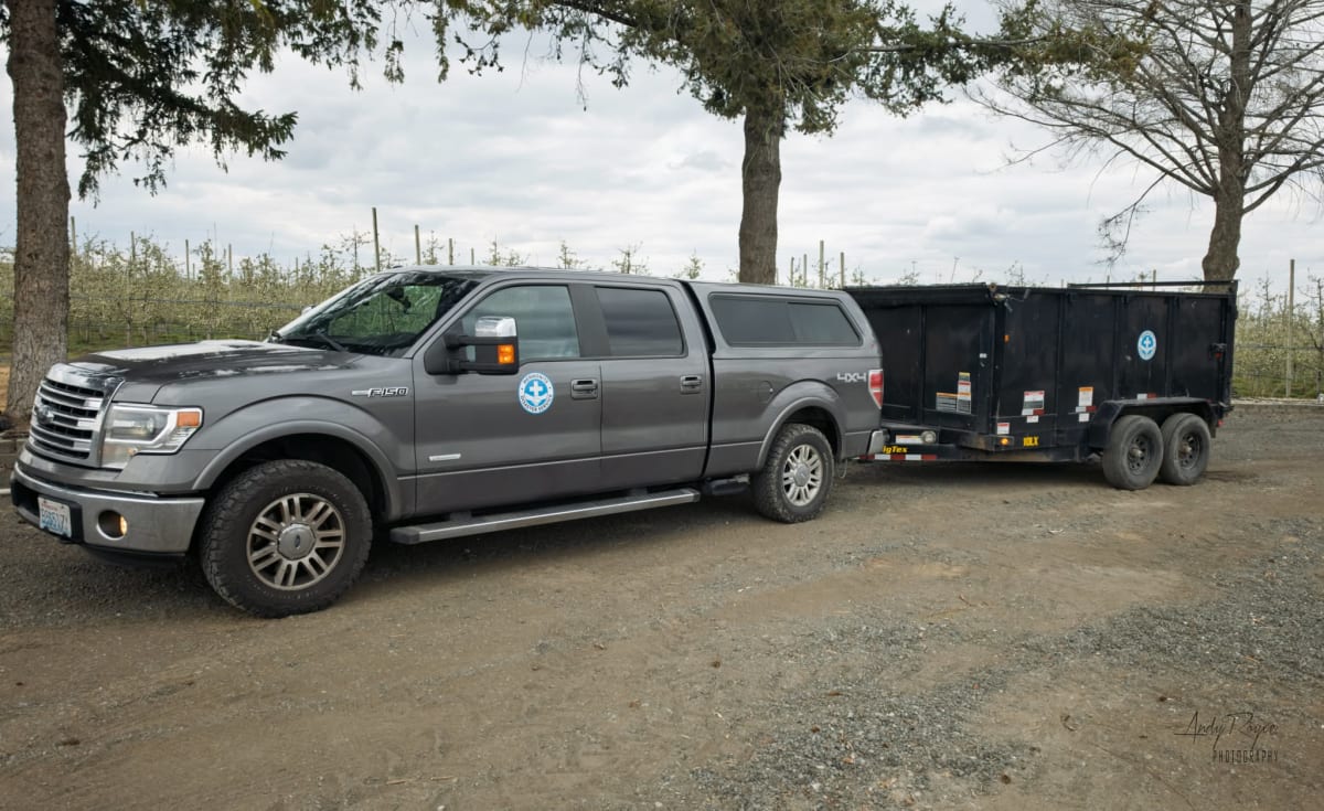 Volunteers loading flood debris and damaged materials into dump trailer at Western Washington home