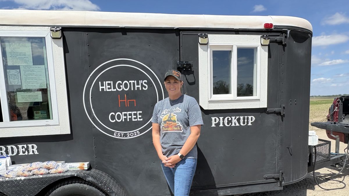 Mobile coffee trailer parked at tornado disaster site with volunteers helping nearby