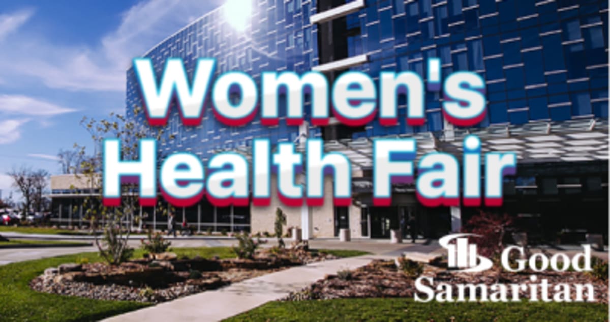 Healthcare professional taking woman's blood pressure during community wellness screening event