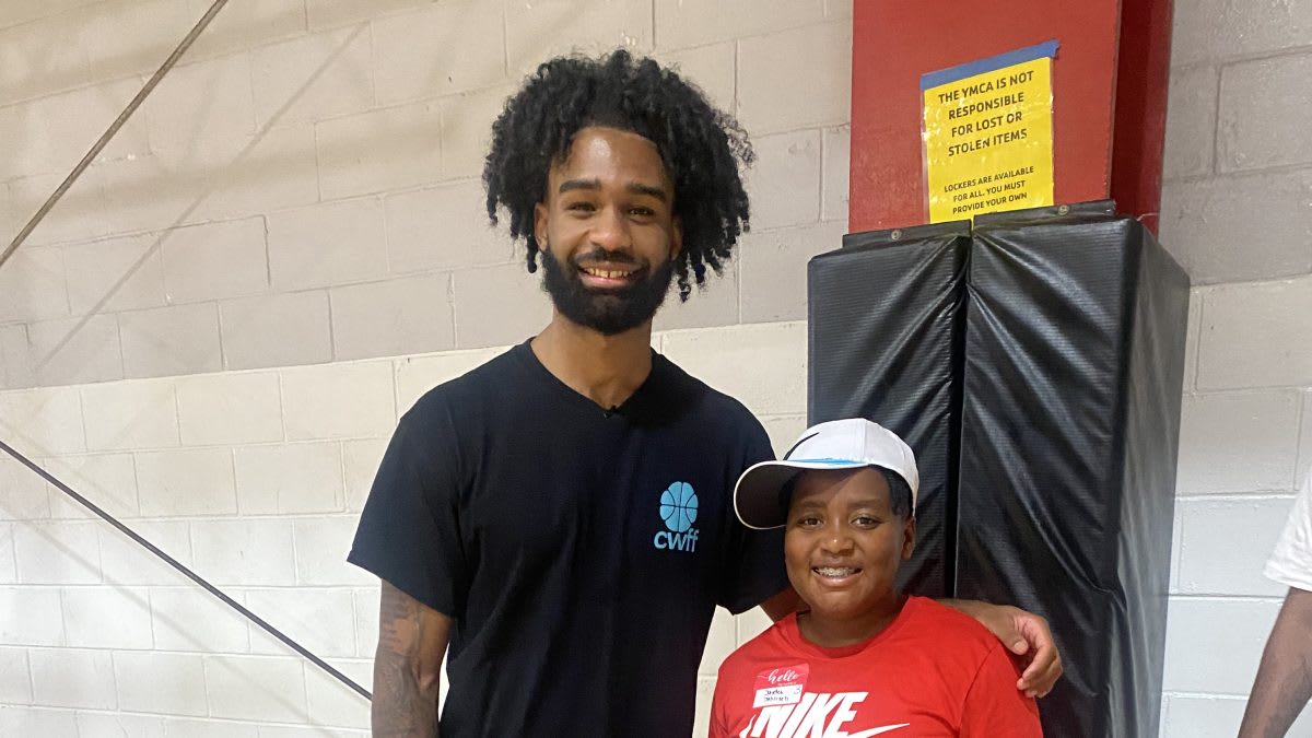 NBA player Coby White engaging with youth at community basketball event in Goldsboro YMCA