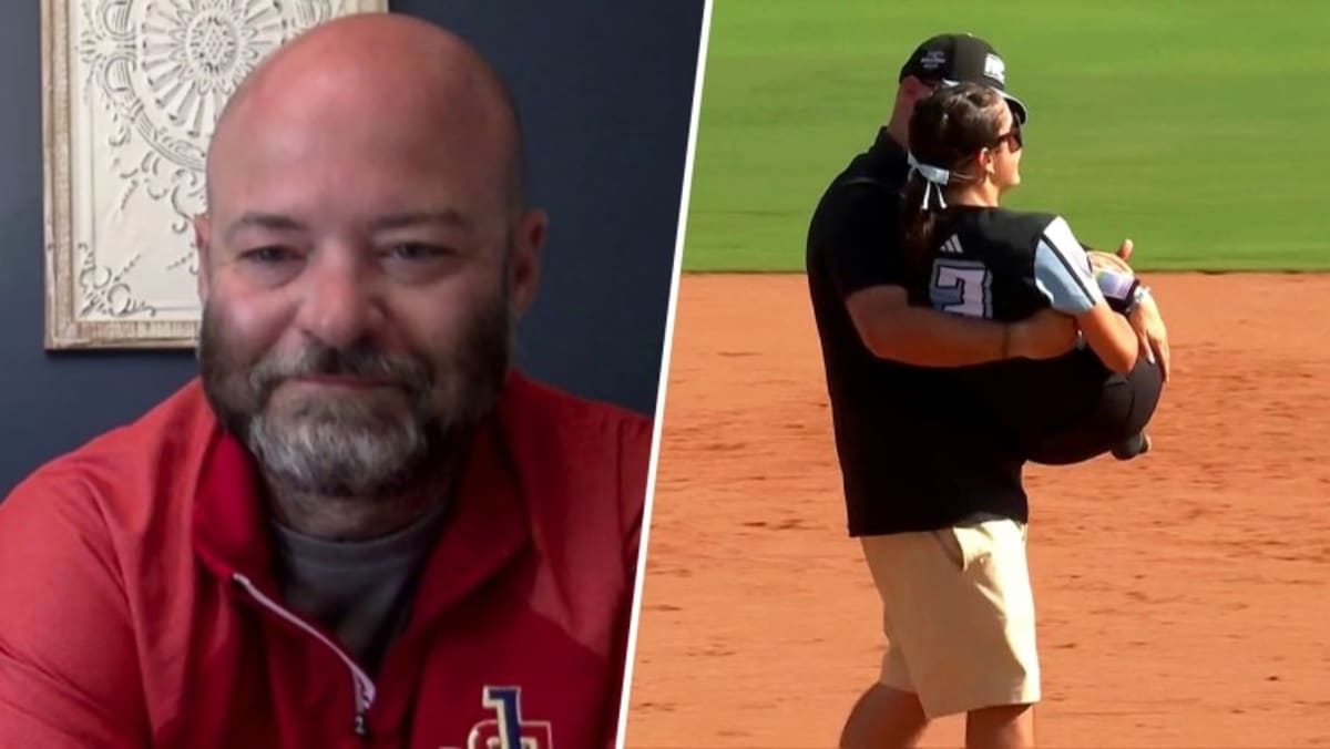Coach Ben Catarozzoli carrying daughter Sophie onto softball field during championship celebration