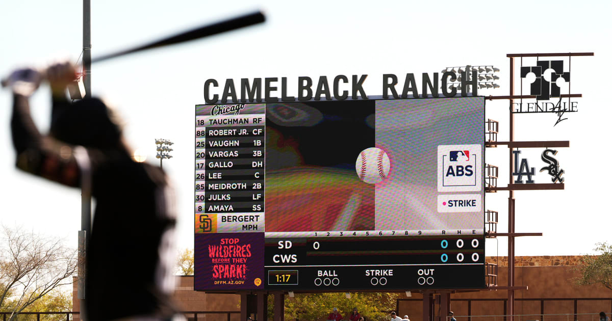** Baseball umpire behind home plate calling strike as digital strike zone overlay appears on stadium screen