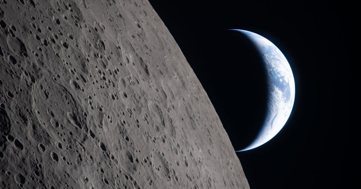 Stunning view of moon's cratered surface with Earth visible in distant space background