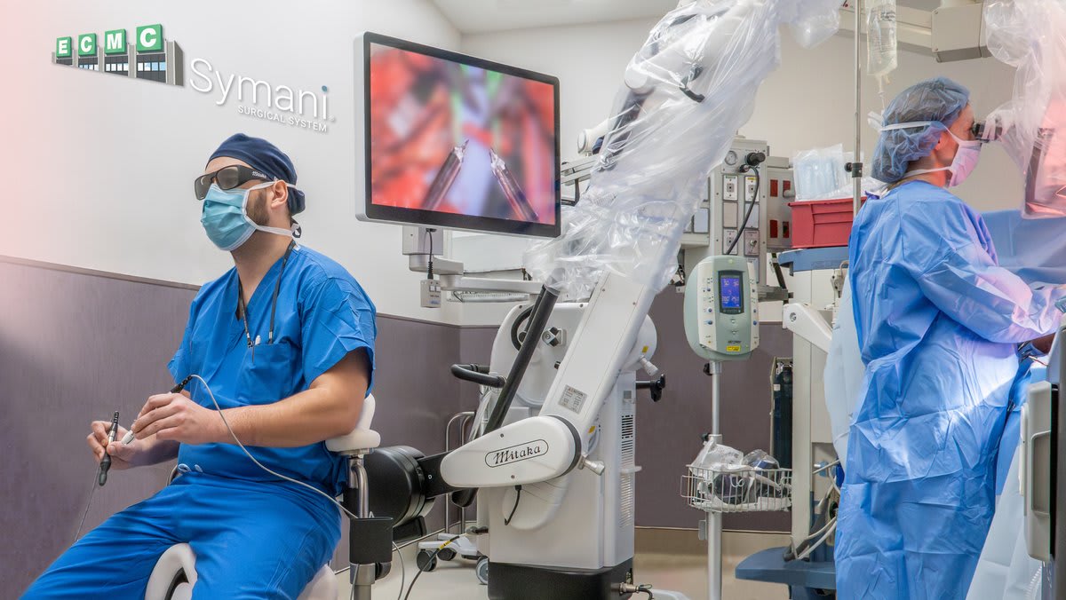 Robotic surgical arm performing precise microsurgery on tiny blood vessels in operating room