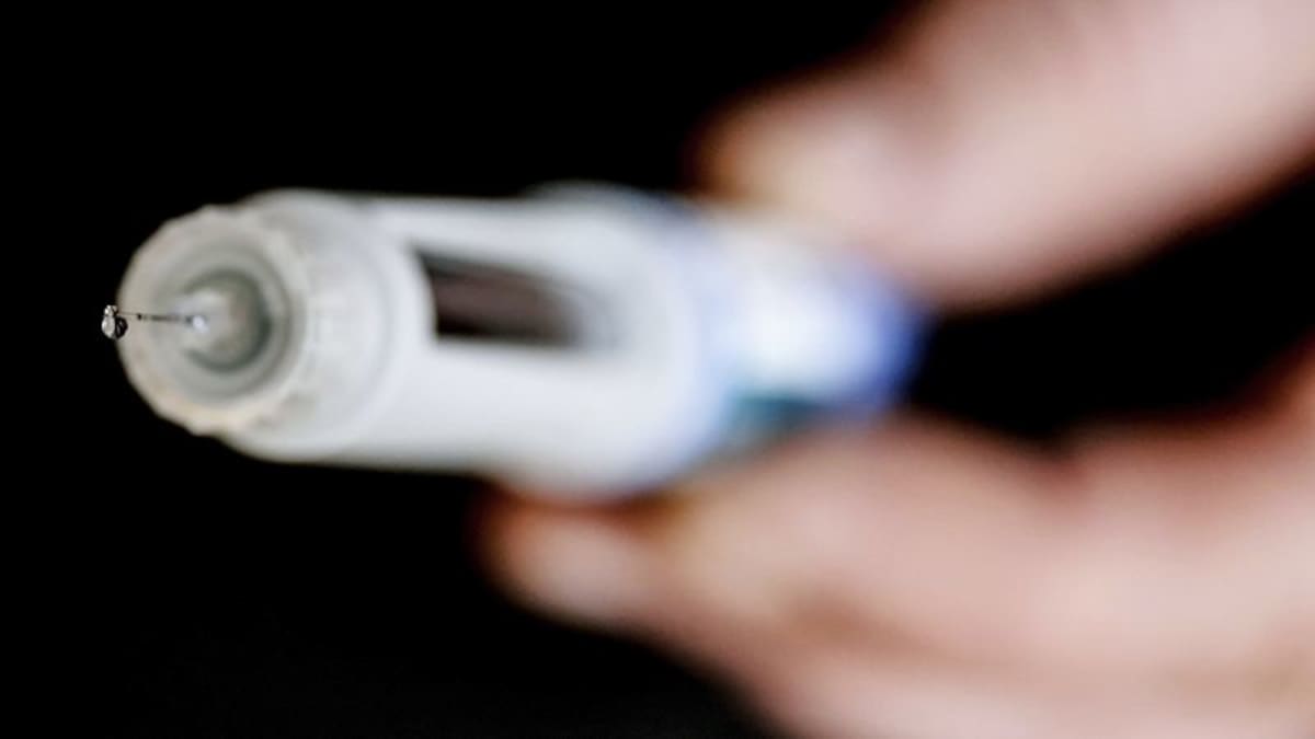 Medical researcher examining liver cell samples in laboratory studying GLP-1 drug effects