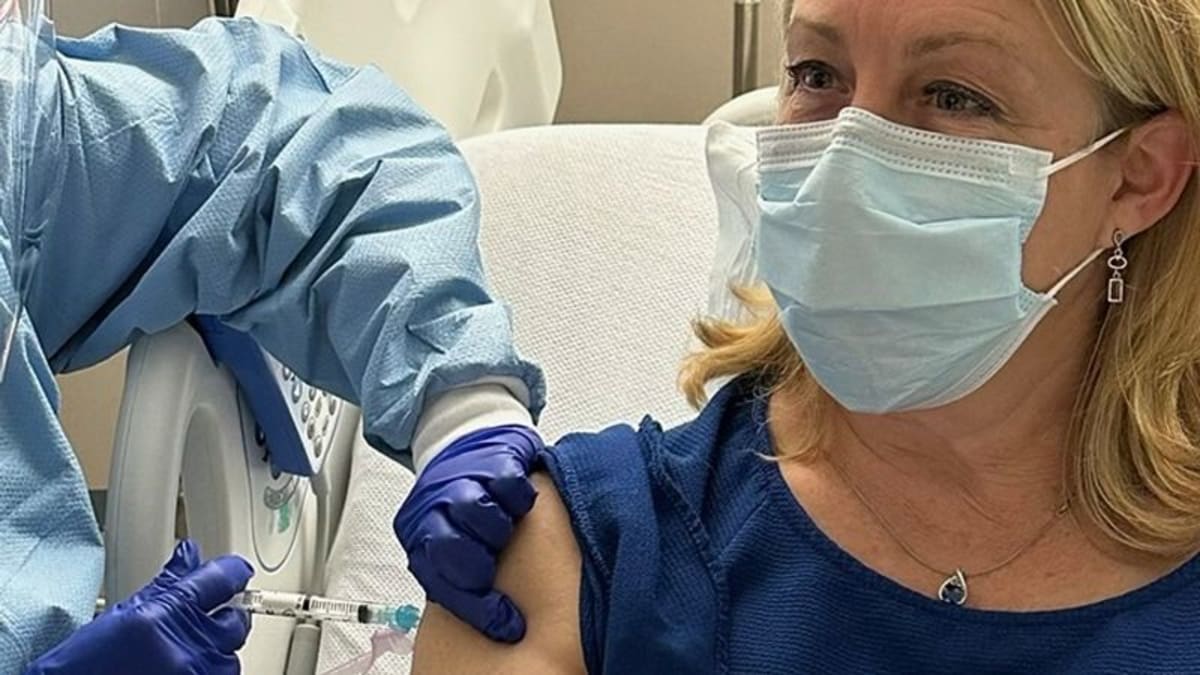 Doctor receiving cancer prevention vaccine injection in medical infusion center