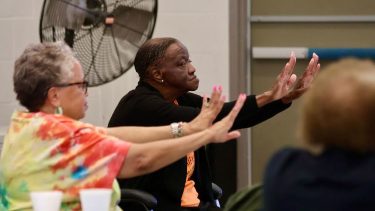 Senior women in yoga class smiling together at Atlanta's Primetime Seniors program