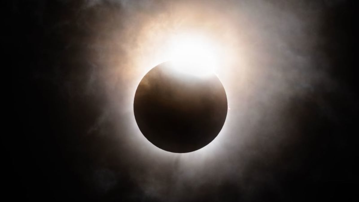Shadow bands creating rippling patterns of light and dark across the ground during a solar eclipse
