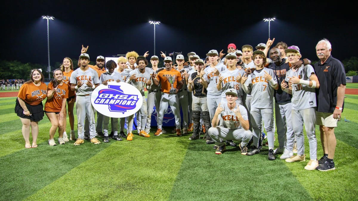 Kell Longhorns baseball team celebrating their first state championship with trophy and coaches