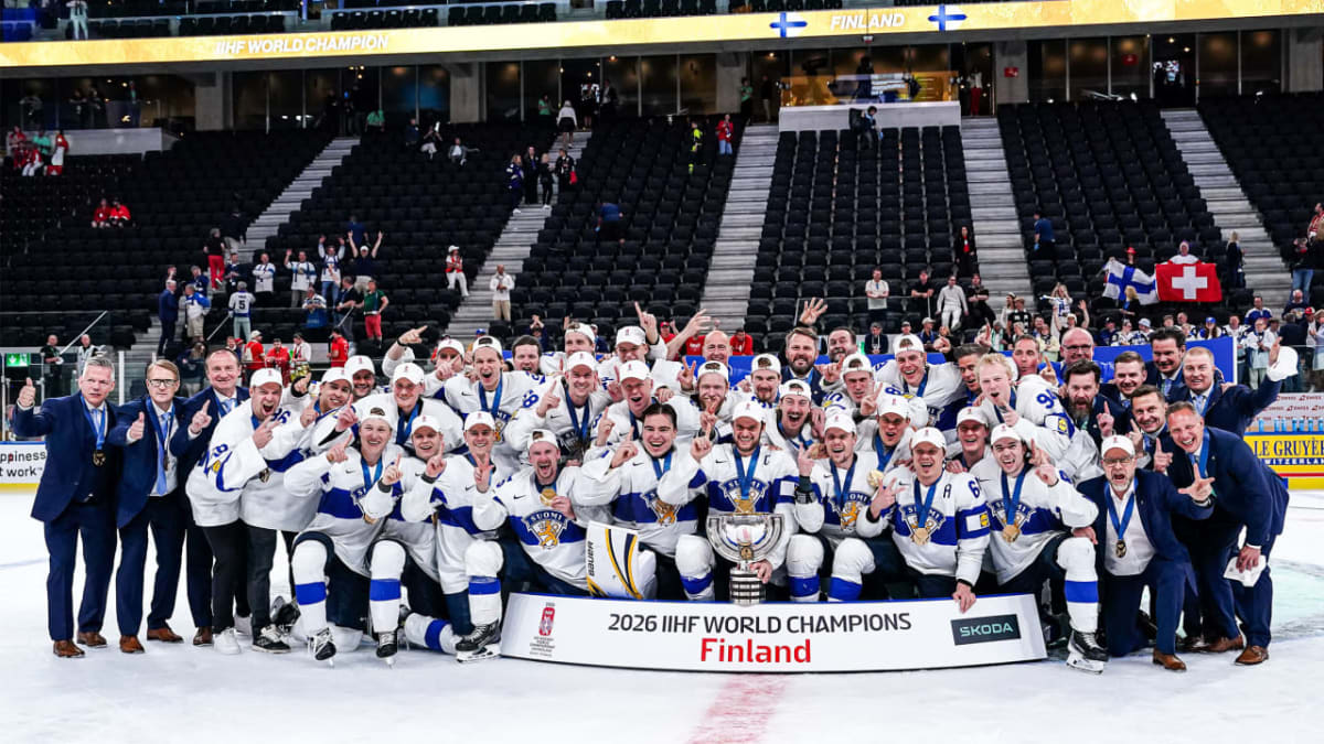 Finnish hockey players celebrating World Championship gold medal victory with raised arms