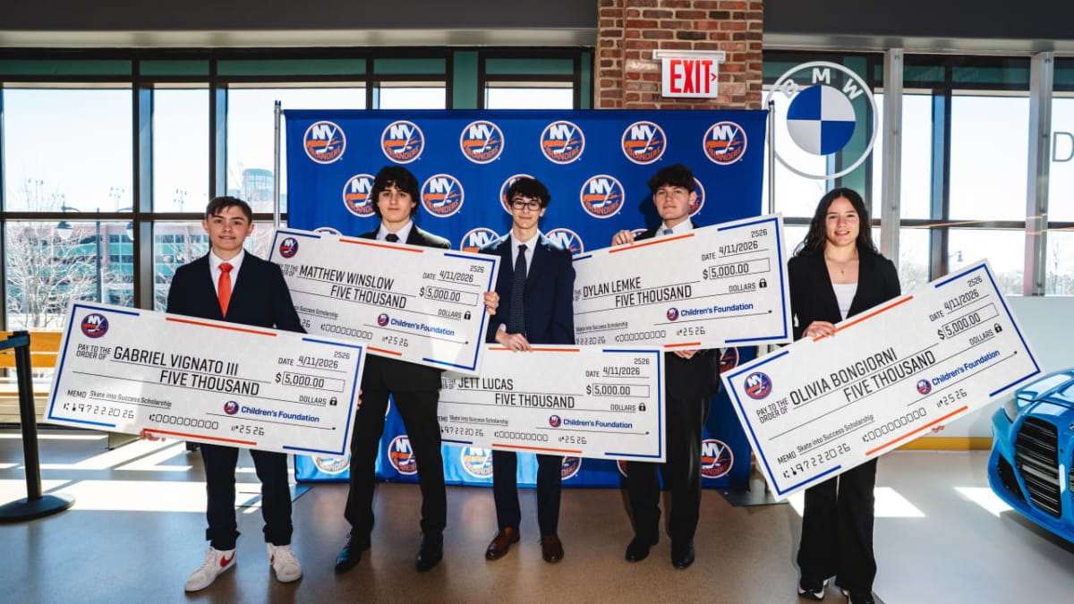 Five high school hockey players in formal attire holding oversized scholarship checks from New York Islanders