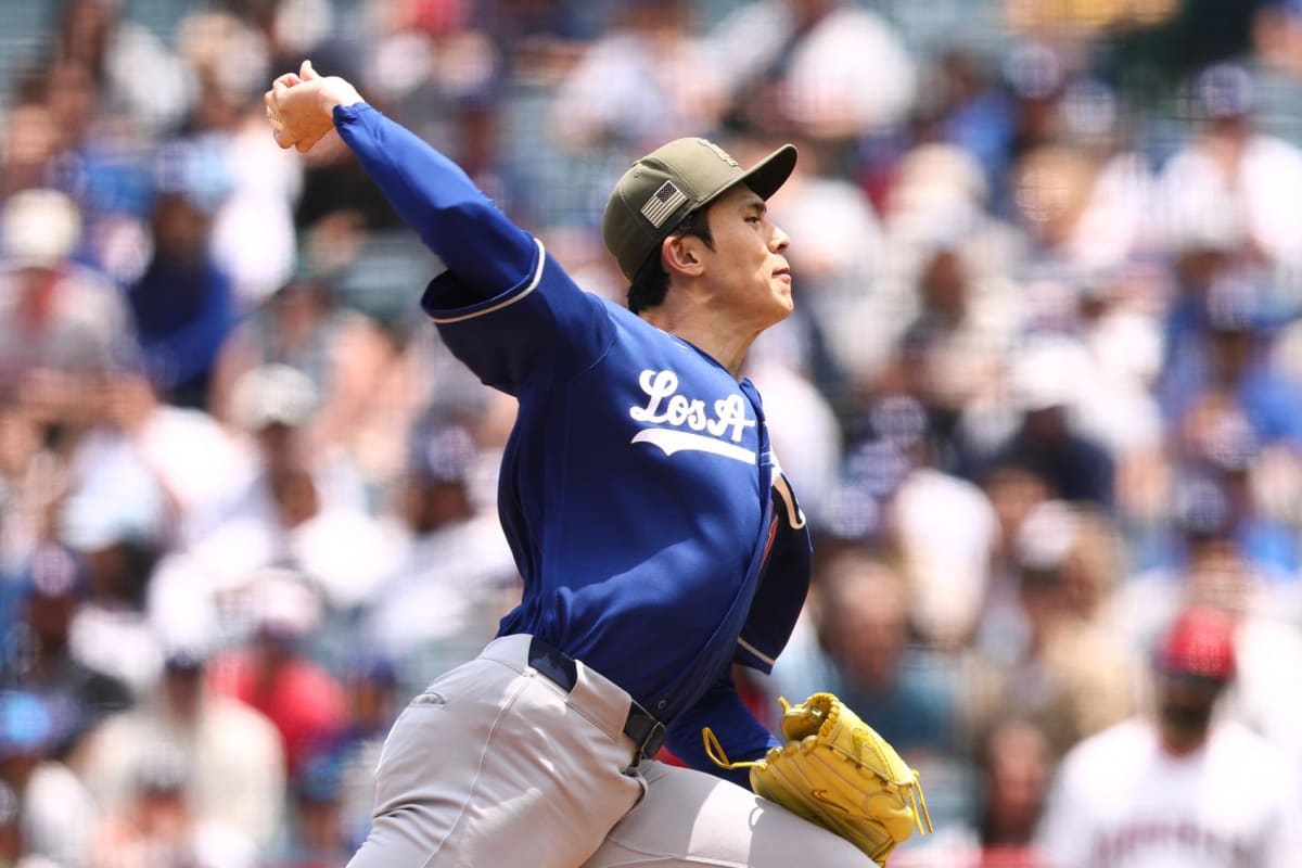 Los Angeles Dodgers pitcher Roki Sasaki winds up to throw during baseball game