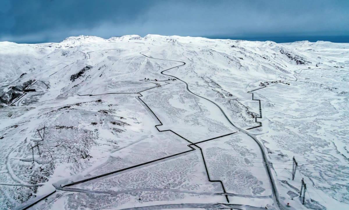 Geothermal pipelines carrying hot water across volcanic Icelandic landscape to power homes