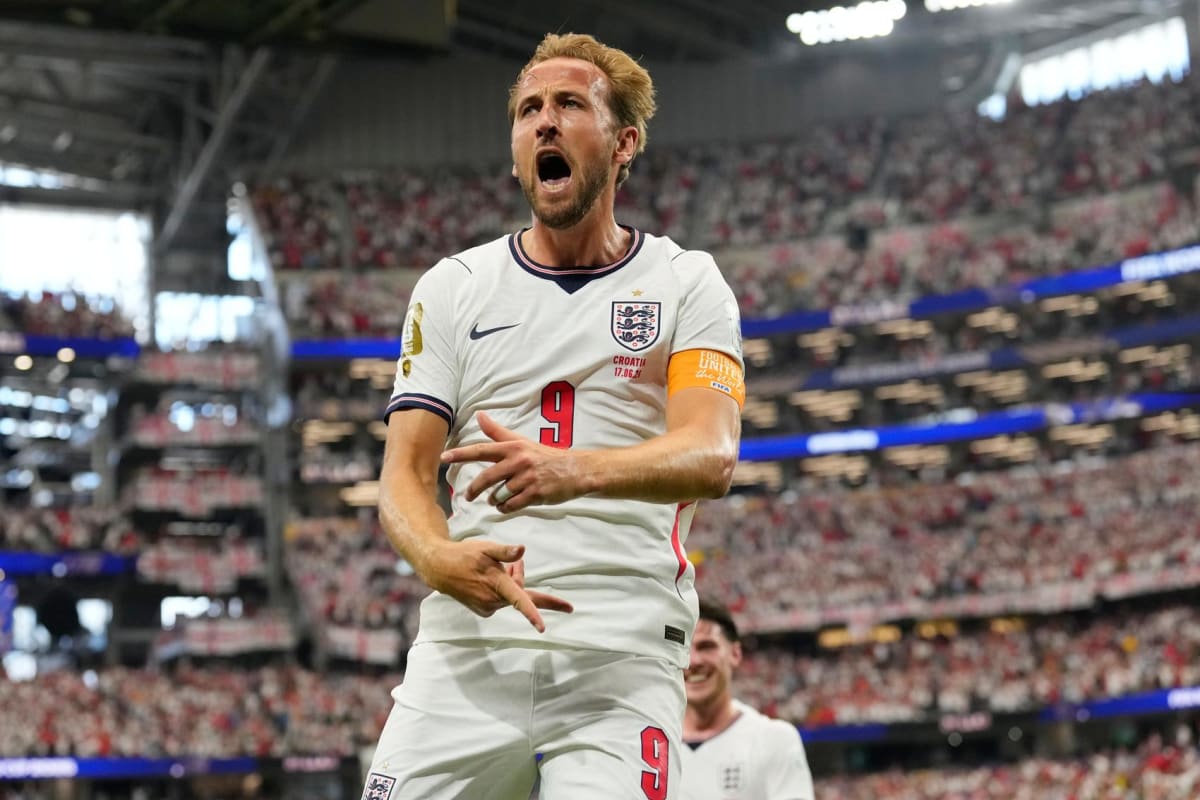 Harry Kane celebrating in white England jersey after scoring goal against Croatia