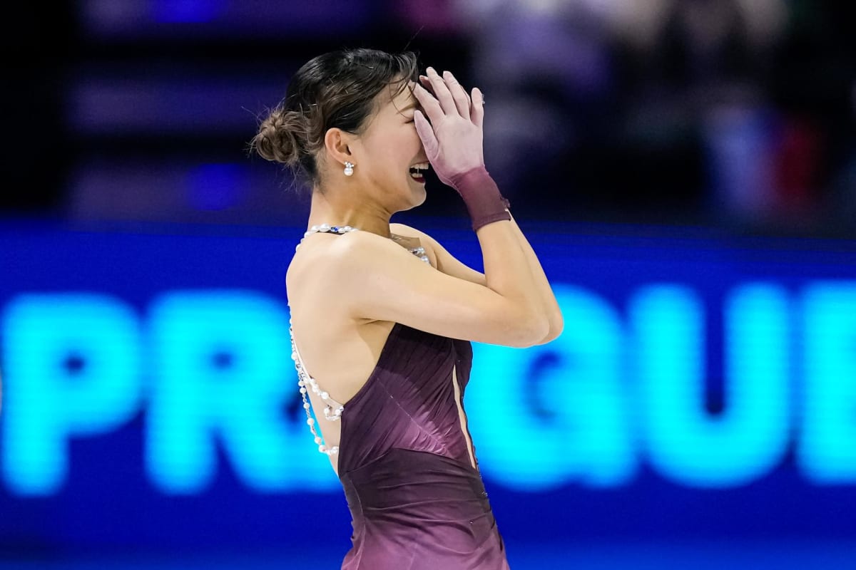 Kaori Sakamoto celebrates on ice after winning her fourth world figure skating championship in Prague