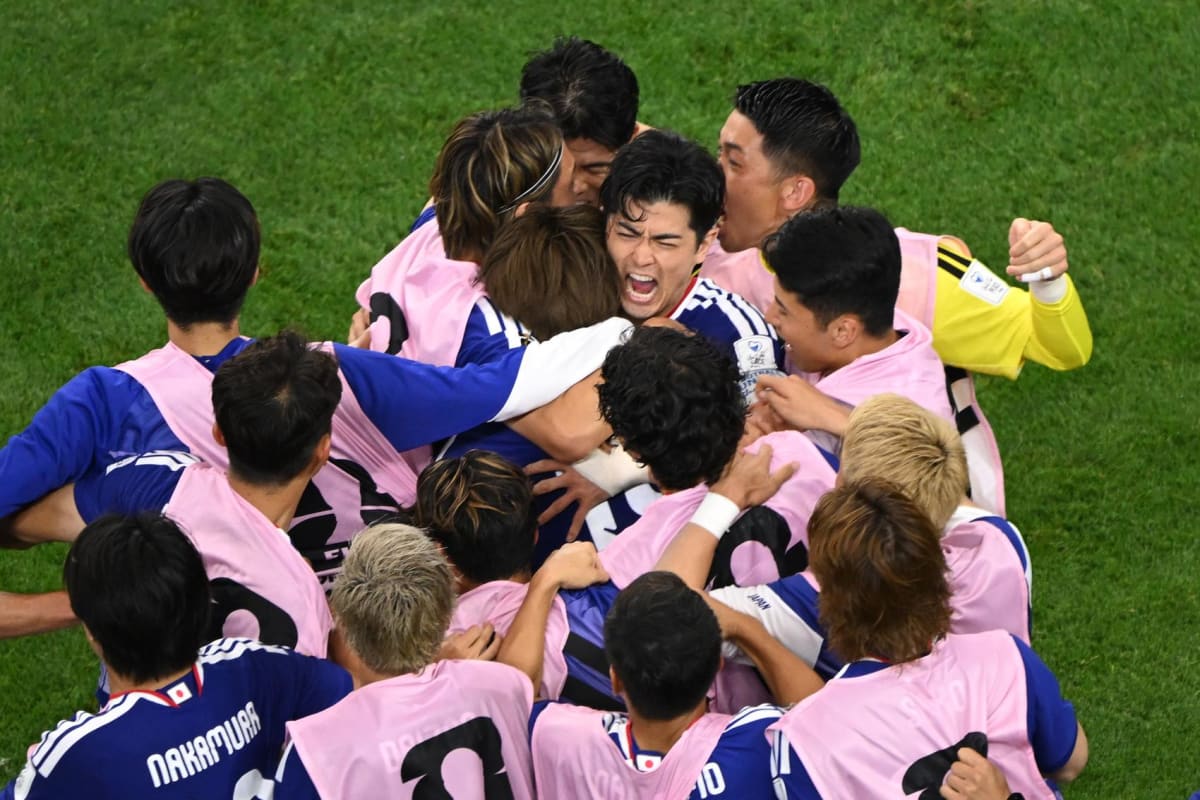 Japan soccer fans celebrating enthusiastically during World Cup match against Netherlands in Texas stadium