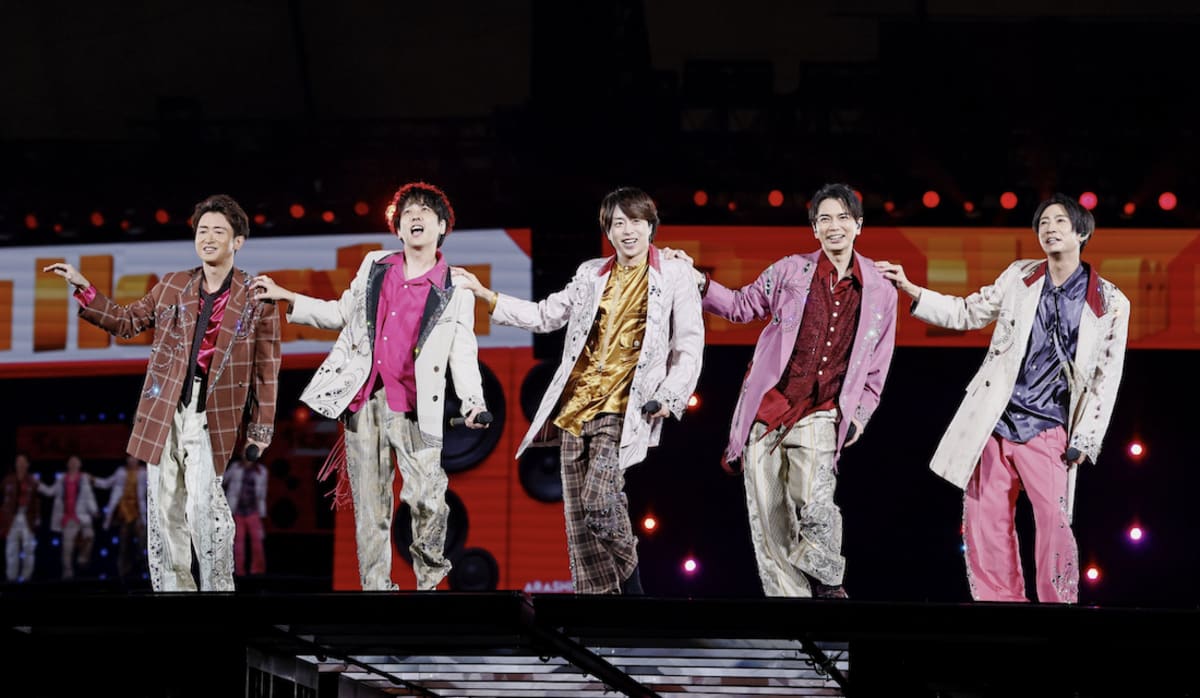 Five members of Japanese boy band Arashi performing on stage at Tokyo Dome