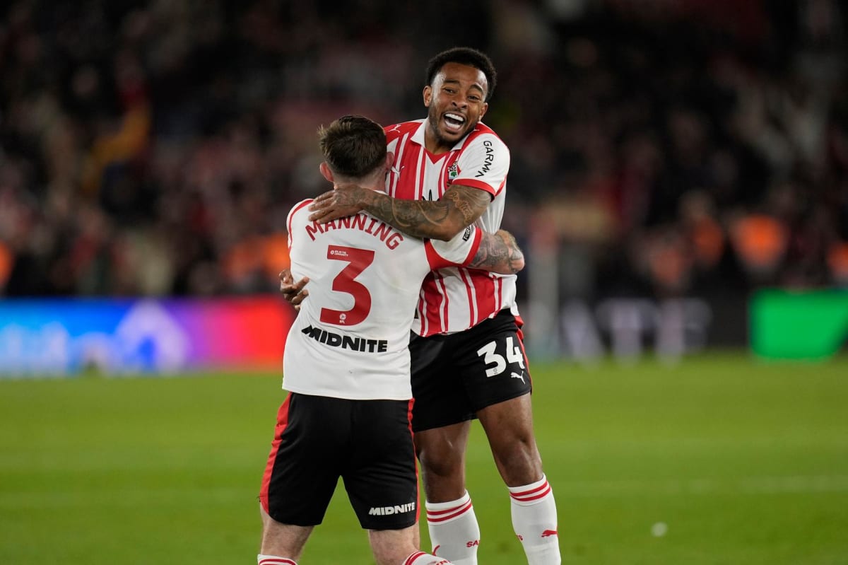 ** Southampton players Welington and Ryan Manning celebrating together on soccer field after playoff victory