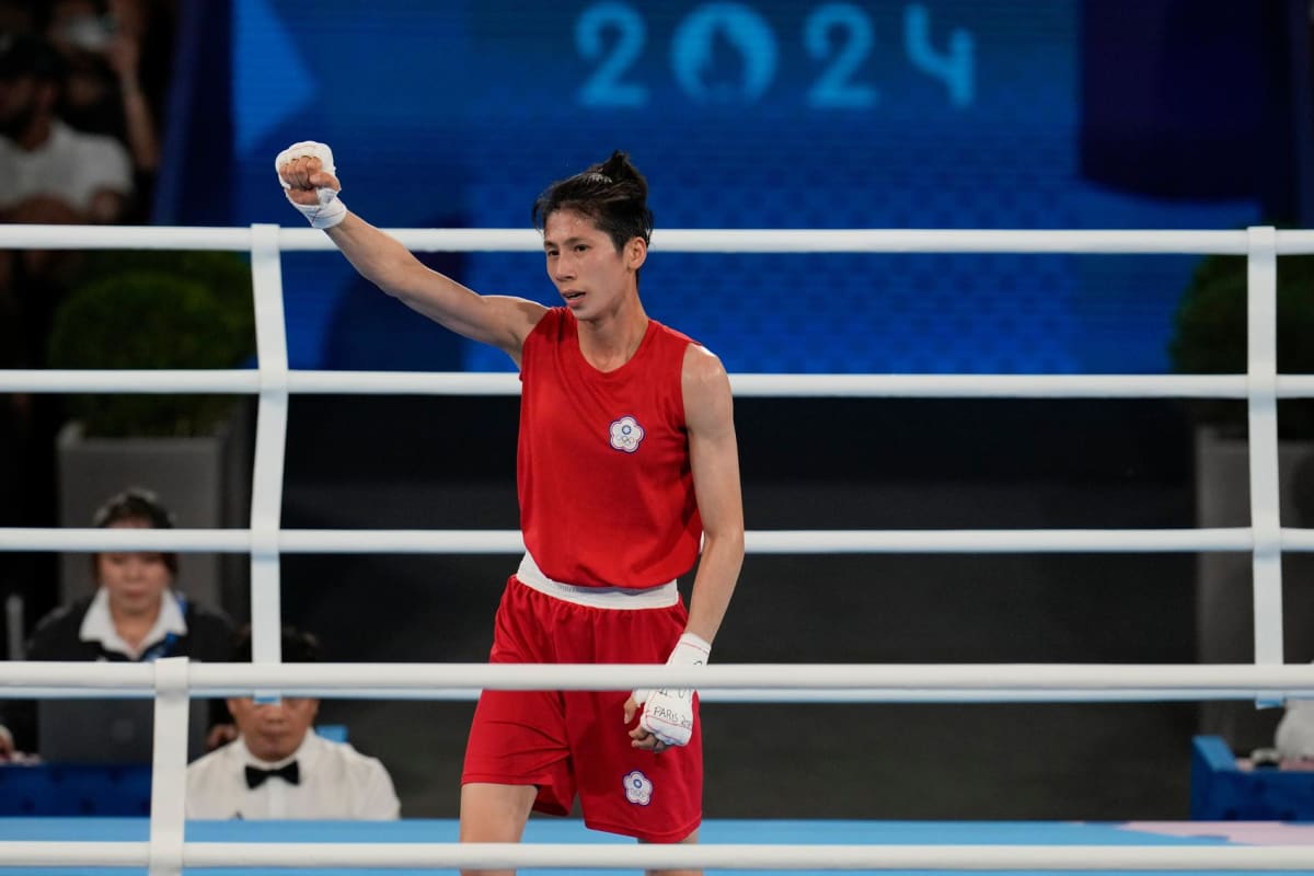 ** Taiwan boxer Lin Yu-ting celebrating with raised fists after winning Olympic gold medal in Paris