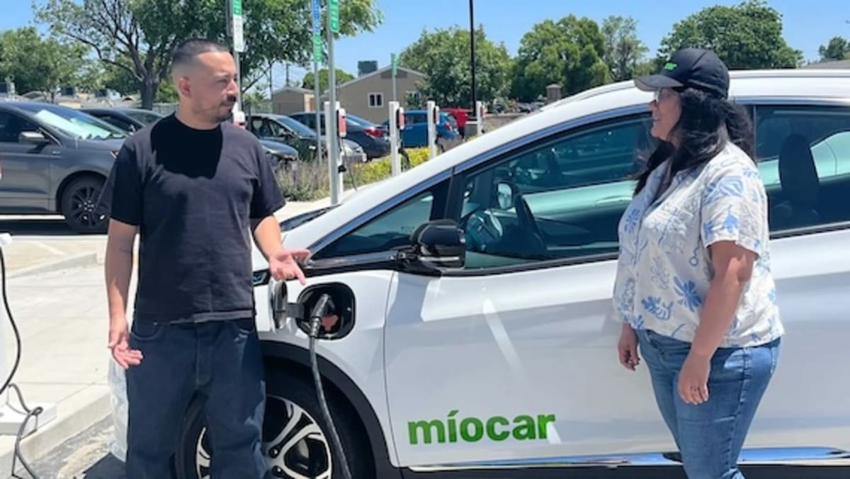 Electric Chevy Bolt charging at Míocar station in Stockton California community hub