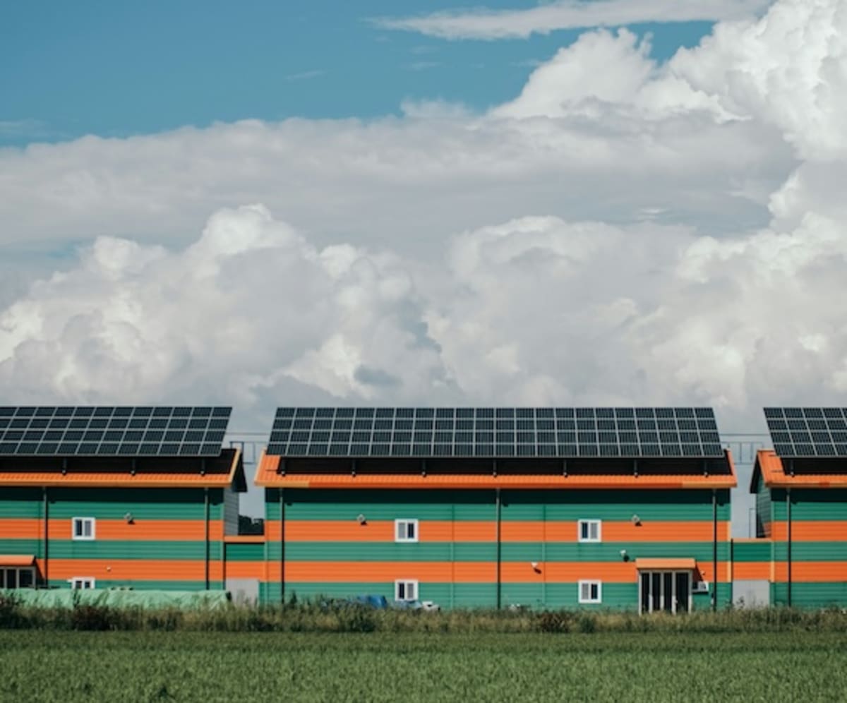 Solar panel array in rural South Korean landscape with mountains in background