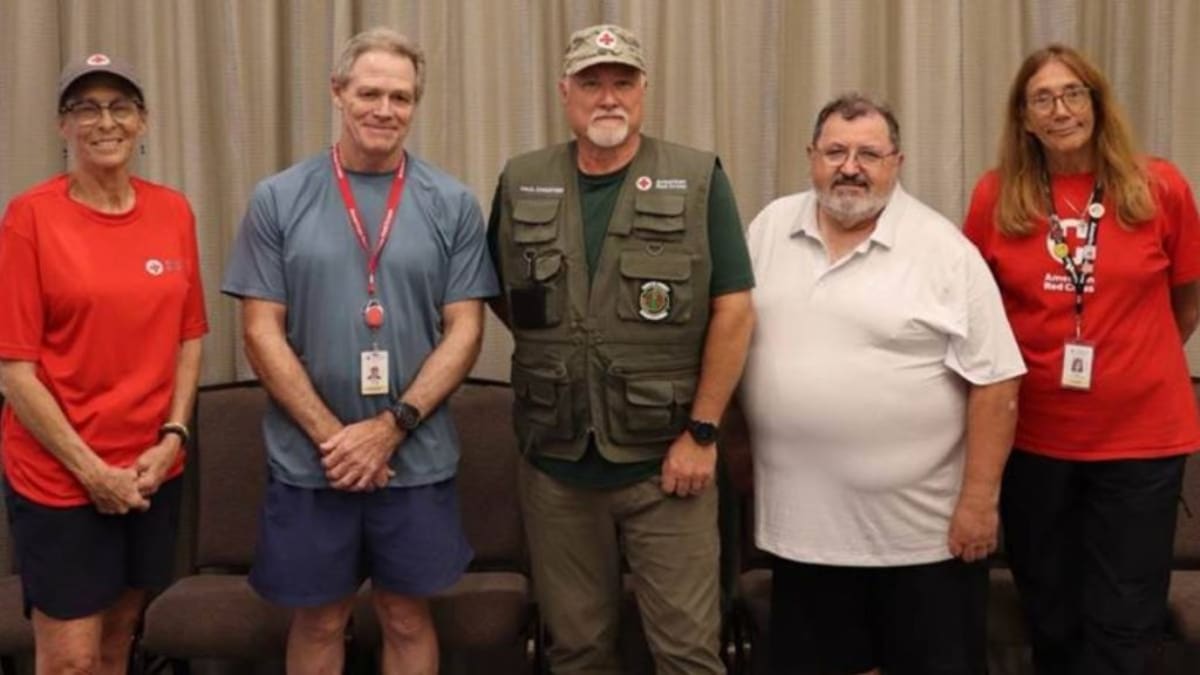 ** Five Red Cross volunteers standing together at Honolulu hotel before departing to help typhoon survivors