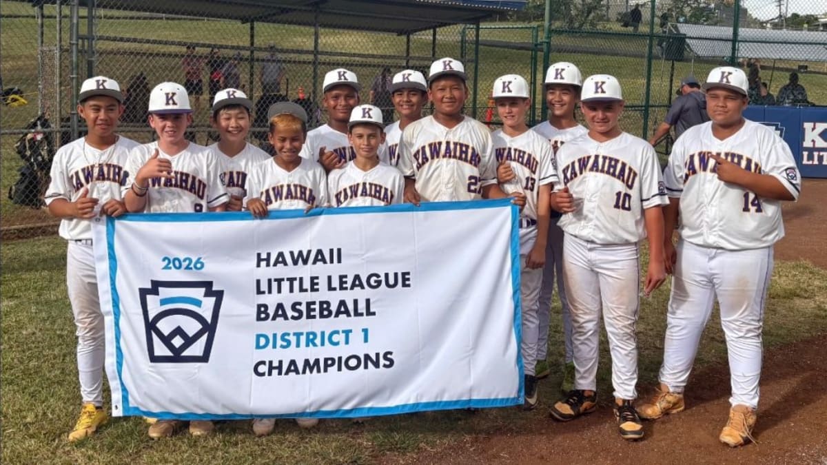 Young baseball players from Kawaihau Community Little League celebrating together on field