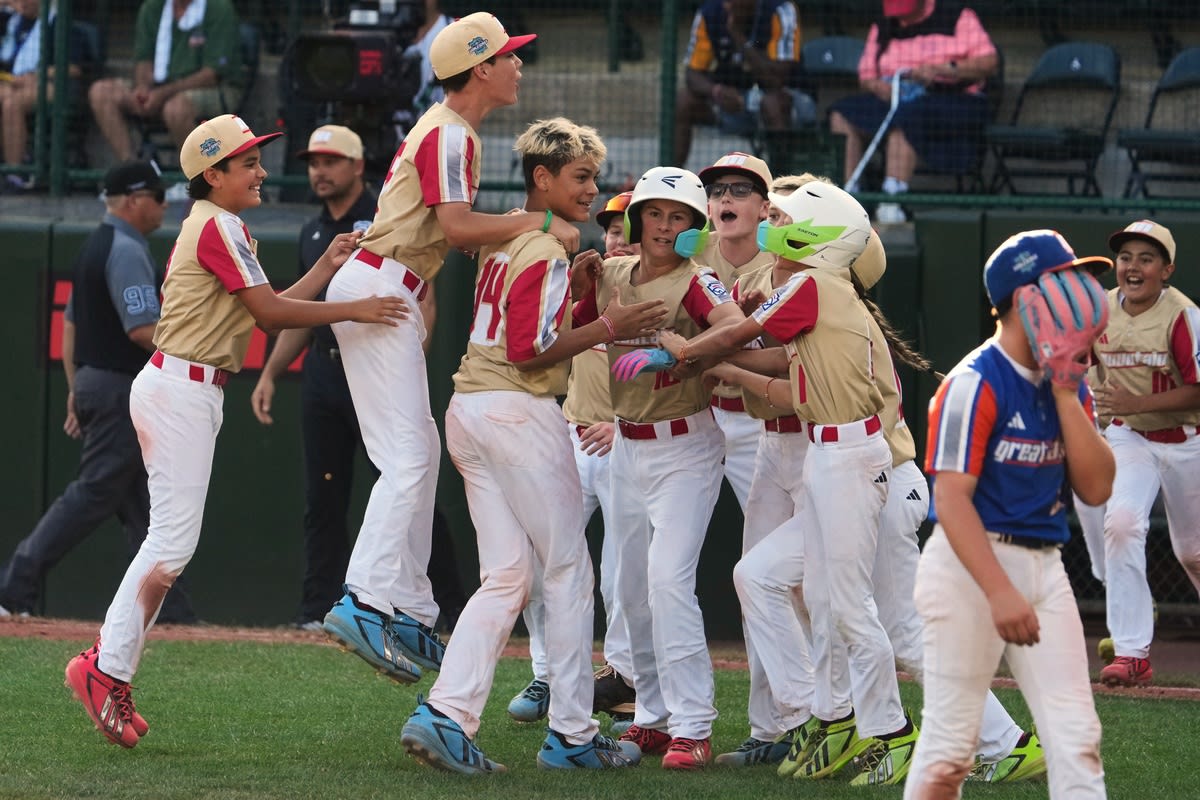 Young baseball players in Henderson Nevada uniforms celebrate after winning U.S. championship game