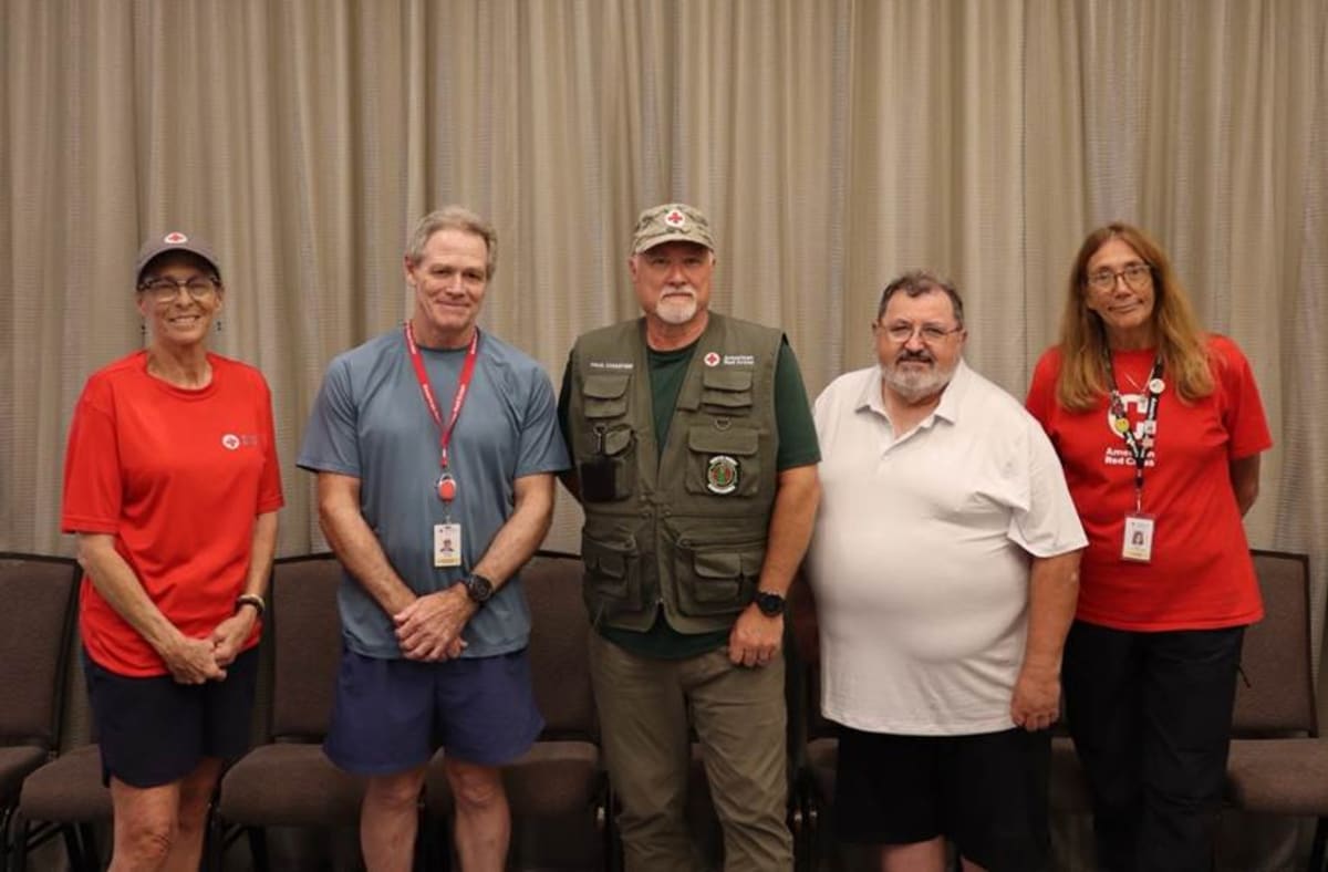 Five Red Cross volunteers standing together at Hilton Hawaiian Village before deploying to Guam
