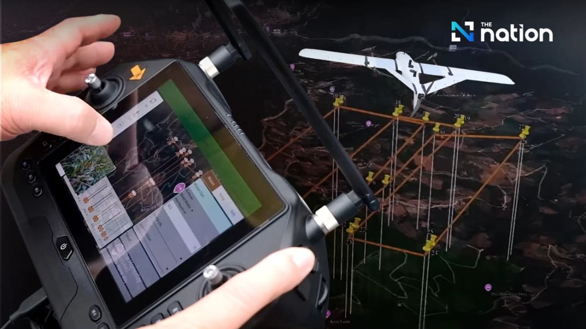 AI-powered surveillance drone flying over misty forest canopy in Northern Thailand mountains