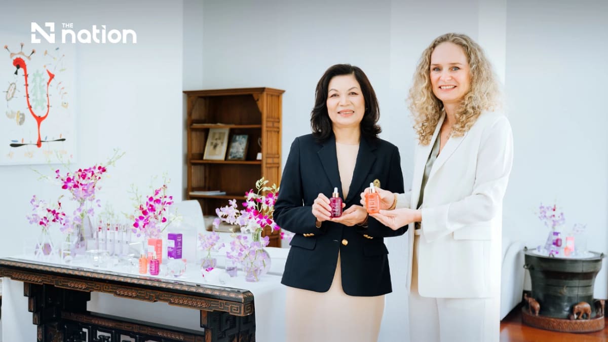 Laboratory researcher examining Thai orchid extracts for pharmaceutical skincare development in modern facility