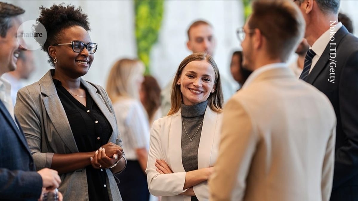 Early-career researchers networking and having conversations at a professional conference reception