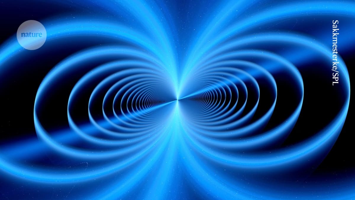 ** Miniature high-powered magnet resting in researcher's palm next to laboratory equipment