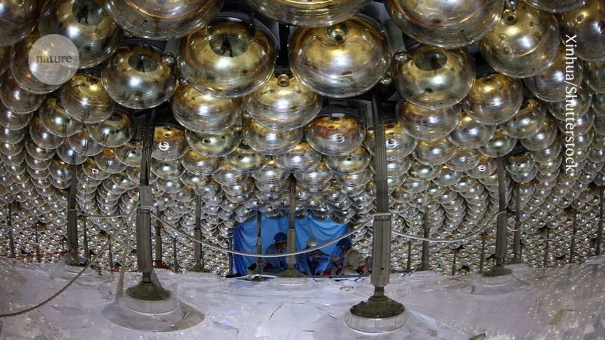 Gold-colored photomultiplier tubes lining the interior of China's underground neutrino detector