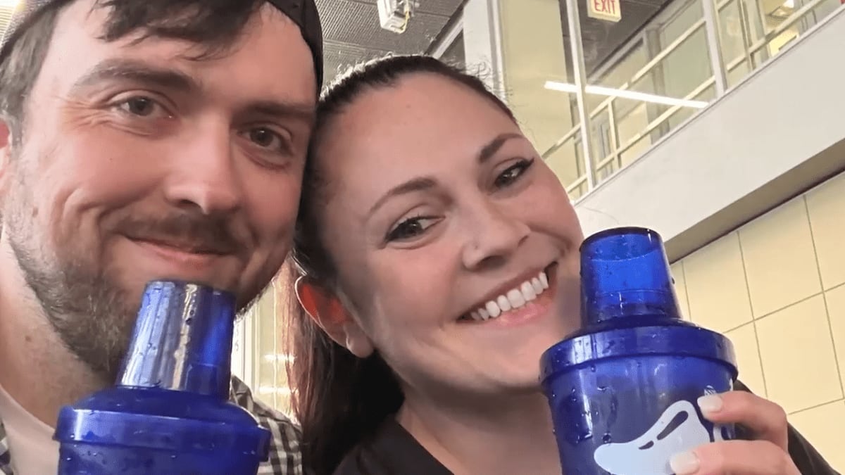 Couple embracing at Chili's restaurant bar inside O'Hare Airport after surprise proposal