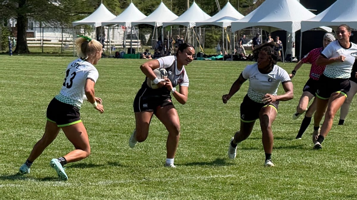 Female college rugby players competing in tackle during national championship tournament
