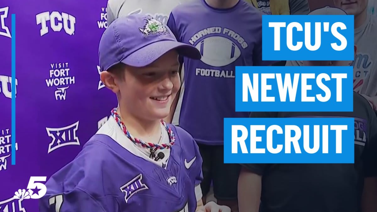 ** Young cancer survivor wearing TCU football uniform smiling with Horned Frogs team and coaches