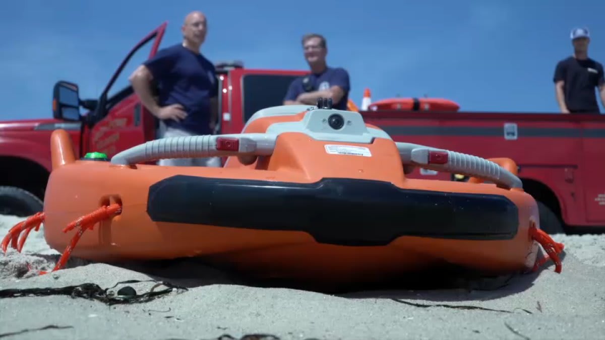 Orange water rescue drone floating in ocean waves near New Jersey beach