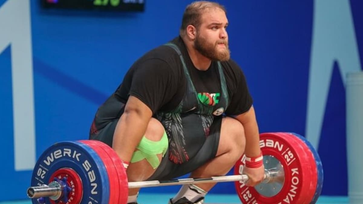 Iranian super heavyweight weightlifter Alireza Yousefi lifting barbell overhead at Asian Championships competition